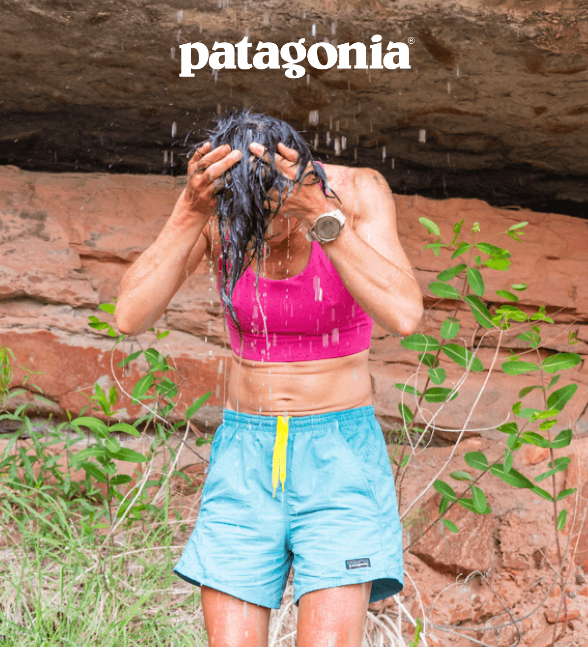 Patagonia. A person stands under a trickling waterfall.