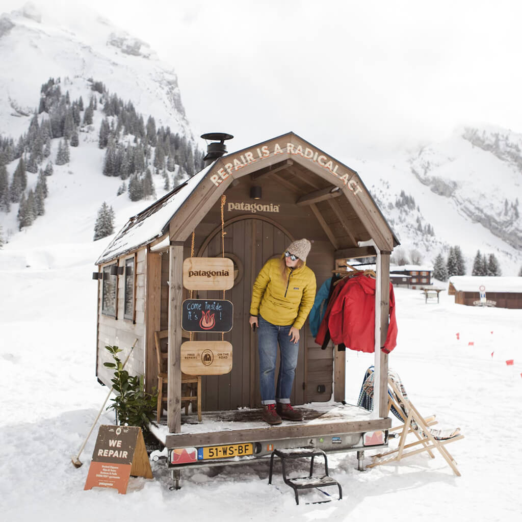Wooden repair hut in a snowy mountain landscape.