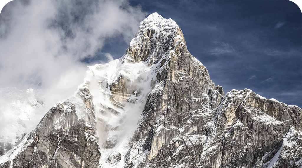 Photo of a gnarly snow-dusted mountain peak.