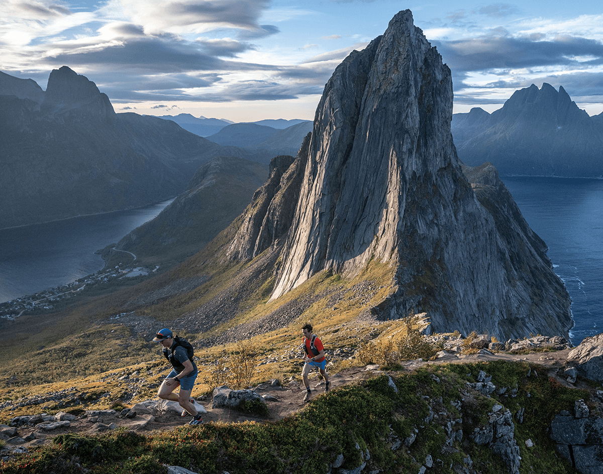 Two runners trail running in the mountains.
