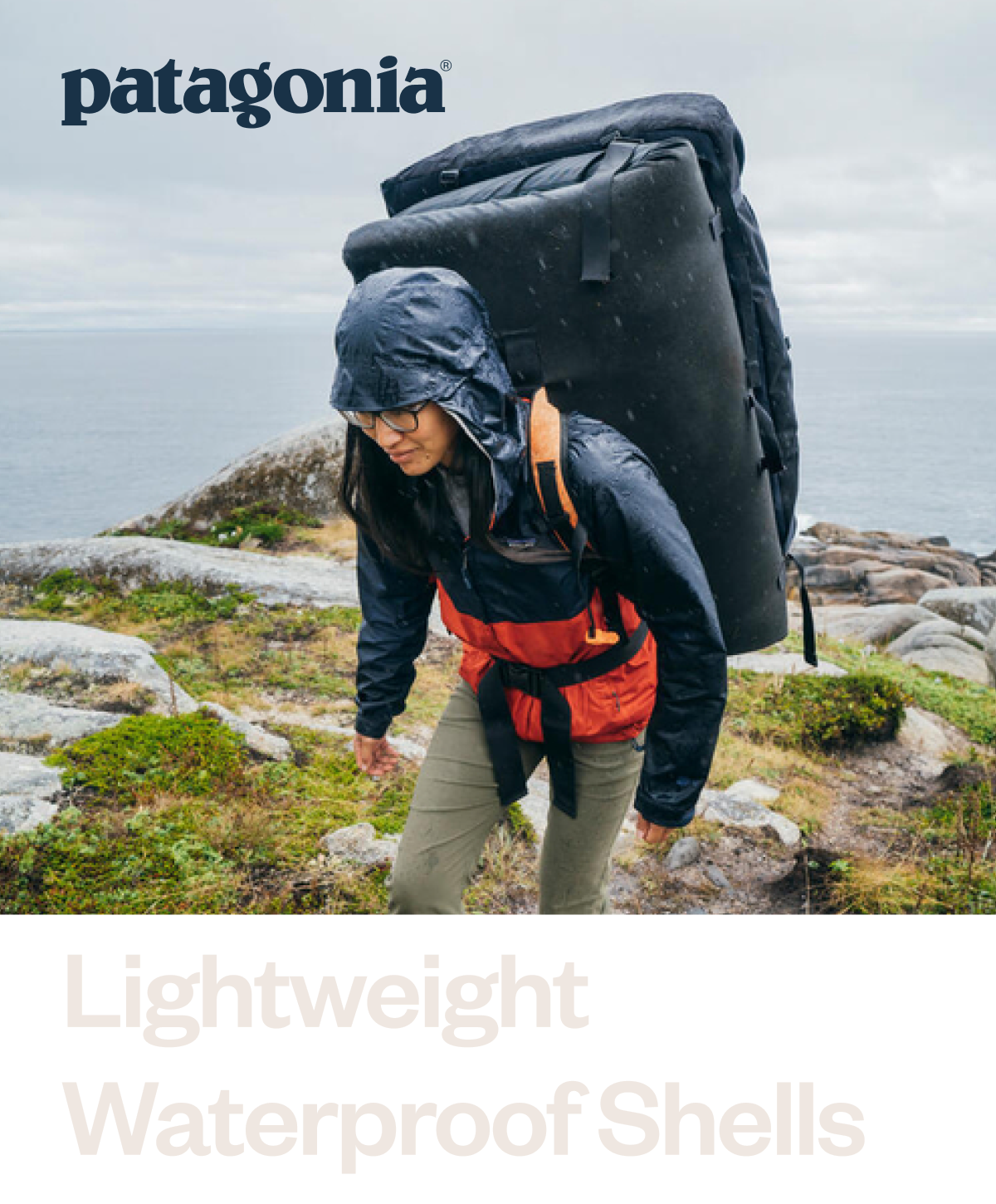  A person walking in the rain while carrying a crash pad for bouldering.   